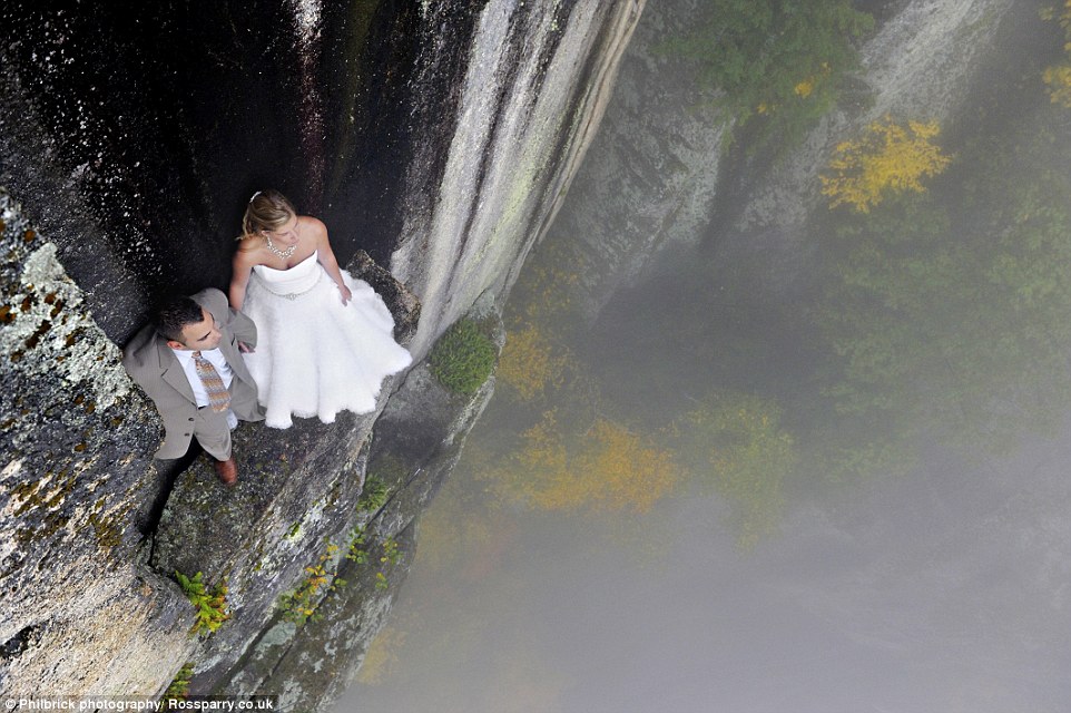 The brave couple can be seen perched on a ledge about 30 feet below the top and 350 feet above the valley floor