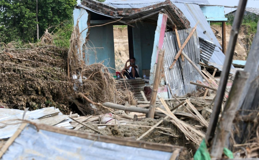A Man Rests In His House Damaged By Flooding Some 250 Kilometers From Nepal's Capital Kathmandu