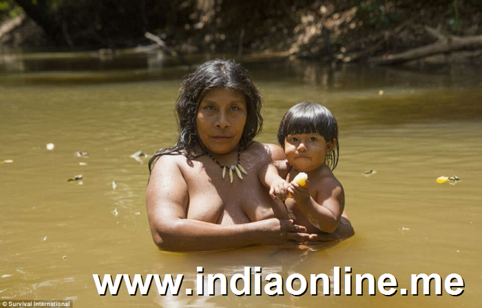 Lifestyle: A woman with a child while bathing in a river in the middle of the forest, which is slowly being eradicated by fire and farming