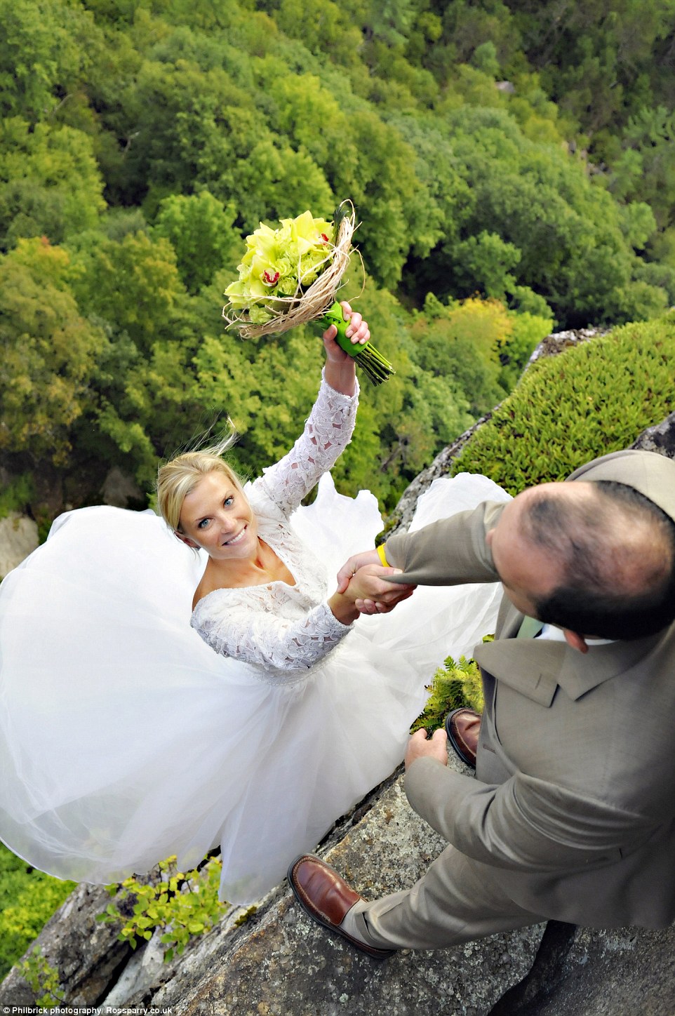 Christie Sulkoski and Kevin Coleman can be seen testing their new marriage to the limit as she holds on to her husband's hand for dear life while dangling from a rocky ledge