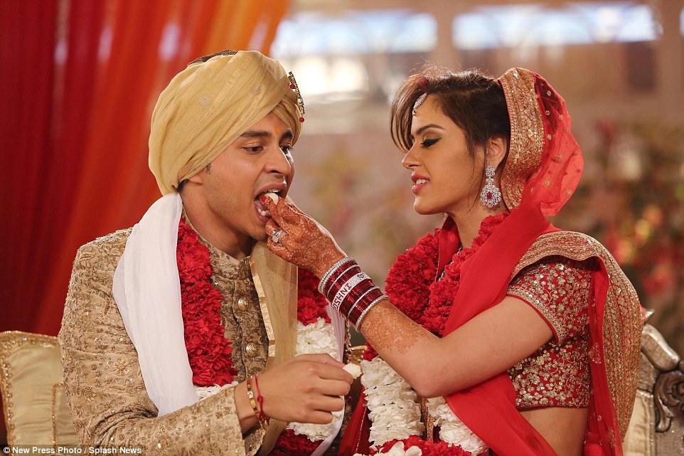 Beautiful bride Roshni feeds  Rohan Mehta during their three-day Indian wedding ceremony held in the Italian city of Florence