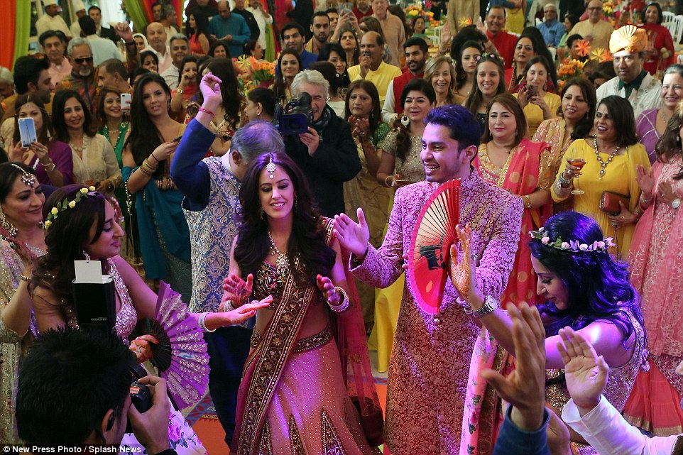 A circle was formed around the newlyweds at the party as everybody clapped while the wedding party entertained with a dance�