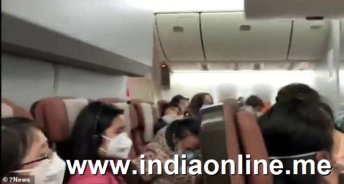 a group of people in a room: Footage emerged showing the Australian citizens aboard the Qantas rescue flight